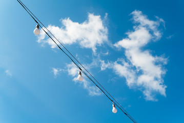 Obraz premium Fluorescent lamps with blue sky and cloud in background