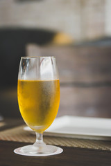 Glass of beer on table in grand room