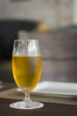 Glass of beer on table in grand room