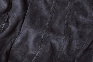 A full page of black suede fabric background texture 
