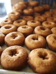 Freshly Made Donuts Getting Ready for Sale