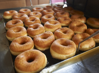 Freshly Made Donuts Getting Ready for Sale