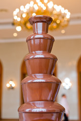 Chocolate fountain placed on a table in wedding day