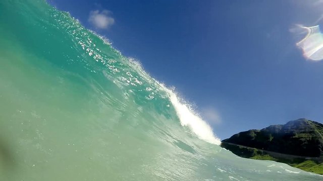 First person perspective of waves crashing in slow motion at beach.