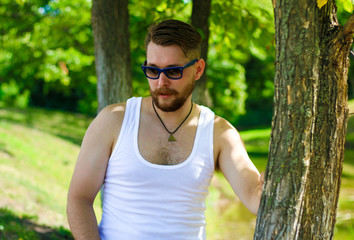 Portrait of a biker in a white t-shirt and sunglasses