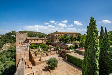Fototapeta na wymiar View of the Nasrid Palaces (Palacios Nazaríes) and the Palace of Charles V in Alhambra, Granada on a beautiful day, Spain 