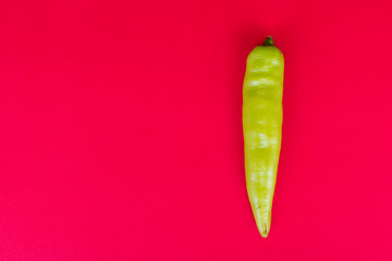 Green Pepper on red background