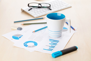 Office workplace with supplies and reports