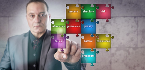 Manager Touching Information Piece In Puzzle