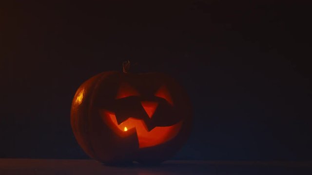 CINEMAGRAPH - CU Halloween carved pumpkin Jack-o-Lantern with candles. Motion photo seamless loop