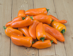 Orange pepper on a wooden table.