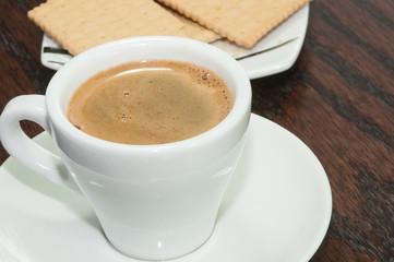 Cup of aromatic espresso  coffee and  biscuits