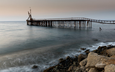 Fototapeta na wymiar Seascape with deserted jetty during sunset