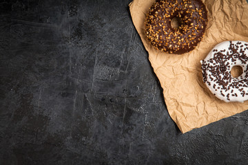 Tasty donuts on dark background