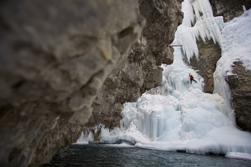A male ice clmber tackles some steep ice in Johnstone  Canyon, Banff National Park, AB