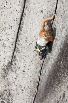 A strong female climber climbing Crescent Crack 10d, Squamish, BC