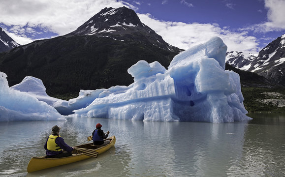Canoeing near iceberg, Coast Mountains, British Columbia, Canada