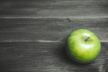 Green apple on grunge gray wooden table.