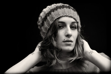 Black and white portrait of girl in stripped winter hat