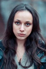 Young girl with deep hazel eyes poses in the autumn park