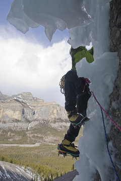An ice climber working his way up Wicked Wanda WI 4, Ghost River, Foothills, Rocky Mountains, Alberta, Canada