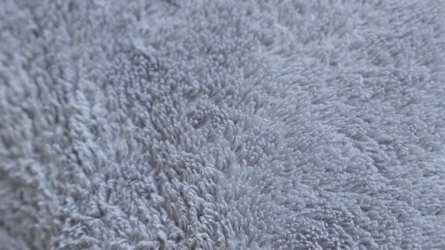 Polyester warming fleece fabric grey material texture 4K 2160p 30fps UltraHD slow tilt footage - Tilting over silver synthetic fibers of polar blanket close-up 3840X2160 UHD video
