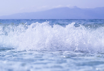 Blue sea or ocean, beautiful waves, drops, sky, mountains
