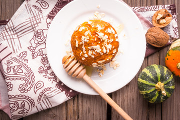 Healthy food - pumpkin muffins with oatmeal. On the rustic table,  surrounded by decorative pumpkins and nuts, top view, copy space