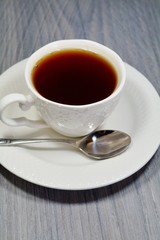 Hot black tea in a white cup
