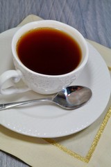 Hot black tea in a white cup
