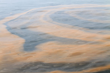 Polluted water, oil, sludge, waste; colorful abstract background.