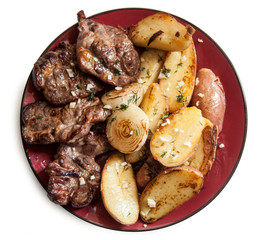 Grilled Steak with potato wedges  on red plate
