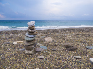 Fototapeta na wymiar Stone pyramid on beach