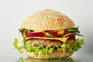 Fresh burger with beef, cheese and tomatoes.