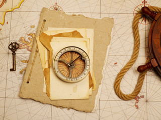 Navigational compass and papers on old map
