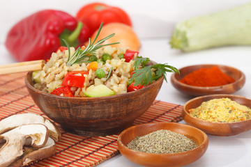 Homemade Chinese fried rice with vegetables and mushroom served in a bowl with chopsticks