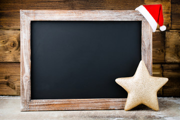 Christmas chalkboard with decoration. Santa hat, stars,  Wooden
