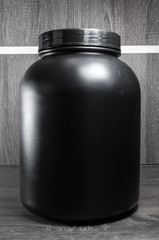 Big black pot of food supplement, no label.