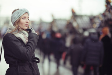 sad pensive woman in winter city street