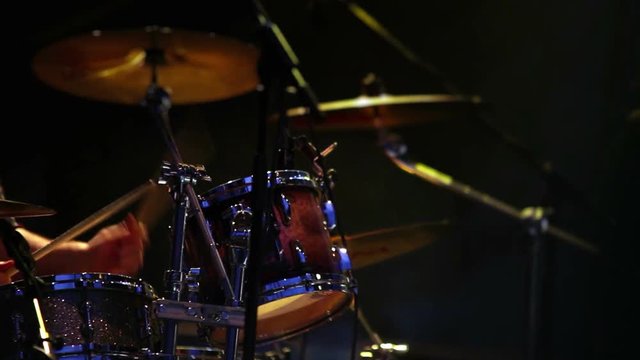 Footage of a rock-drummer performing fast composition in concert