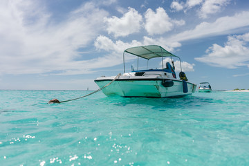 The boat in t the Caribbean Sea and the view of the beach of Cayo Largo, Cuba out of the water