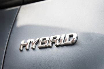 Fototapeta premium Hybrid inscription on the body of a modern car