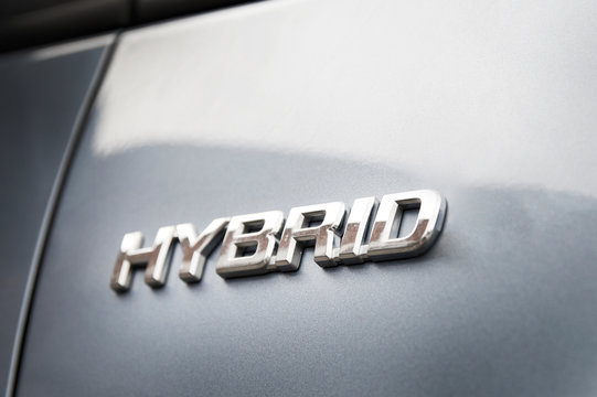 Hybrid inscription on the body of a modern car