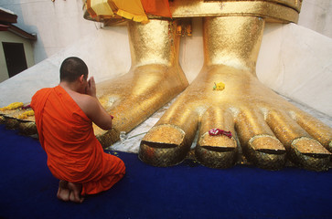 South East Asia, Thailand, Bangkok, Monk makes daily offering to Buddhist statue, Wat  Indrawahim 