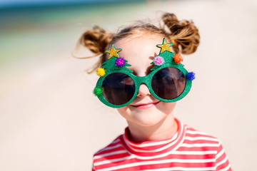 Little girl in funny Christmas glasses