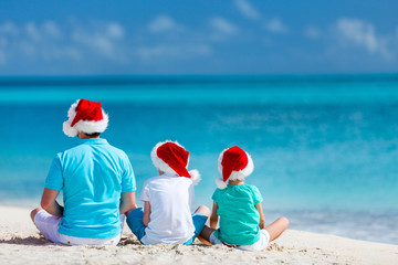 Father with kids at beach on Christmas