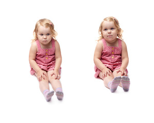Young little girl sitting over isolated white background