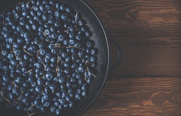 Blueberries on vintage wooden black background top view, healthy food on dark table mockup, berry for smoothie isolated on rustic country board, fresh nutrition closeup, copy space for text design