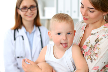 Little boy child  with his mother  after health exam at doctor's office