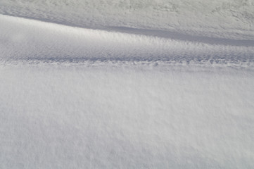 Light and shadow on the curves of snowdrifts.